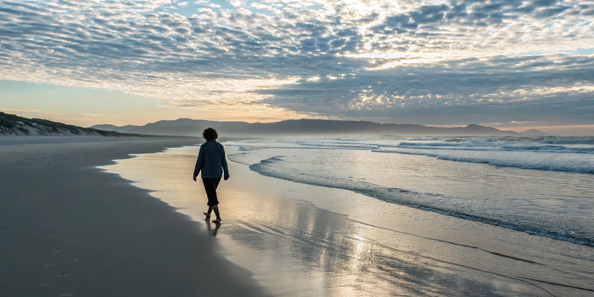 A person finding relief for burning feet by walking barefoot on a cool beach.