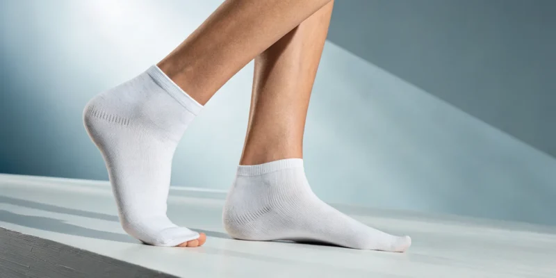 A close-up of a person's feet and ankles, a key area for signs of poor circulation in legs.