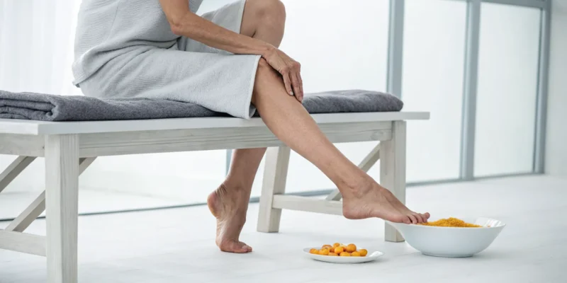 Woman soaking her feet for natural diabetic neuropathy pain relief.